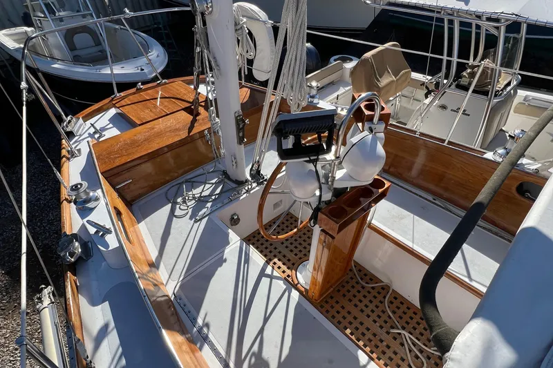 Slide: The Image of 1967 Hinckley Bermuda sailboat deck with wooden accents and nautical equipment. - 23