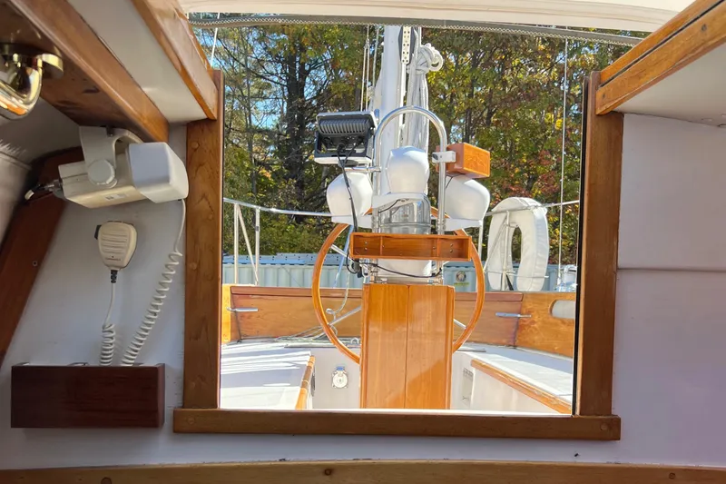 Slide: The Image of Interior view of 1967 Hinckley Bermuda sailboat cockpit with wooden accents and steering wheel. - 27