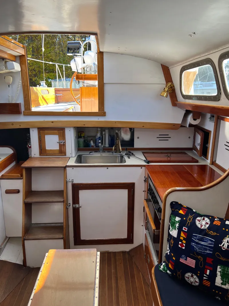 Slide: The Image of 1967 Hinckley Bermuda yacht interior with wooden cabinetry and nautical-themed decor. - 28