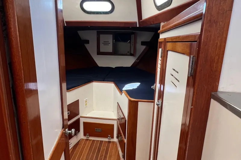Slide: The Image of Interior of 1967 Hinckley Bermuda sailboat with wood paneling and cozy sleeping area. - 31