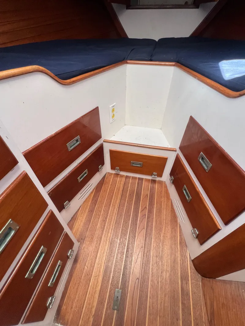 Slide: The Image of 1967 Hinckley Bermuda sailboat interior with wooden drawers and flooring. - 33