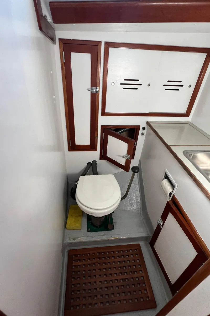Slide: The Image of 1967 Hinckley Bermuda yacht bathroom with wooden accents and compact design. - 36