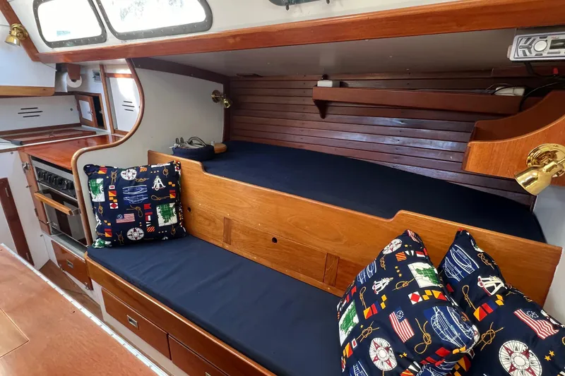 Slide: The Image of 1967 Hinckley Bermuda yacht interior with wooden finish and nautical-themed cushions. - 40
