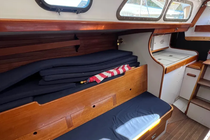 Slide: The Image of 1967 Hinckley Bermuda sailboat interior with wooden benches and cushions. - 41