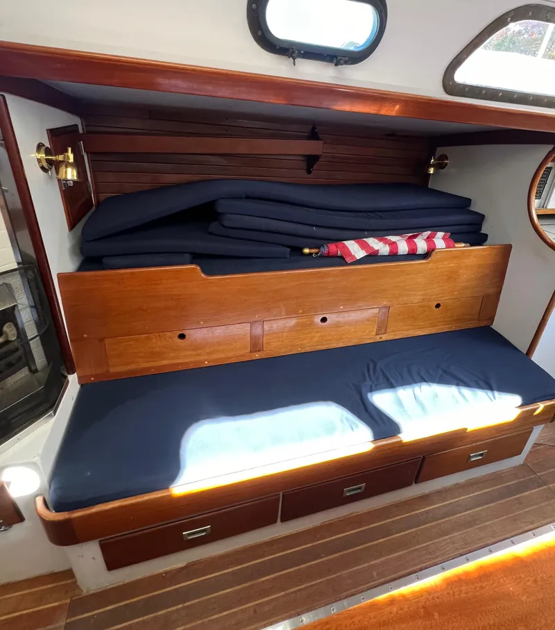 Slide: The Image of 1967 Hinckley Bermuda yacht interior with wooden seating and storage. - 44