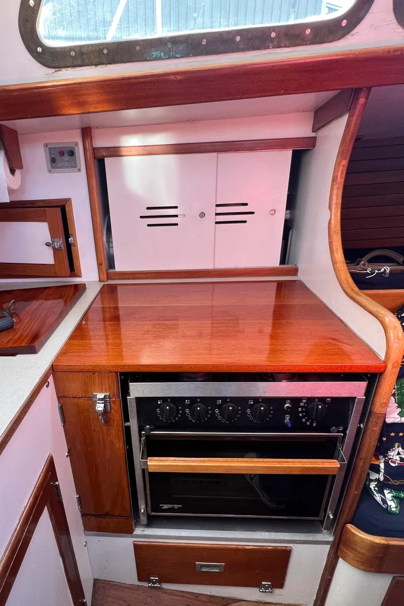 Slide: The Image of 1967 Hinckley Bermuda yacht interior with wooden cabinetry and built-in oven. - 45