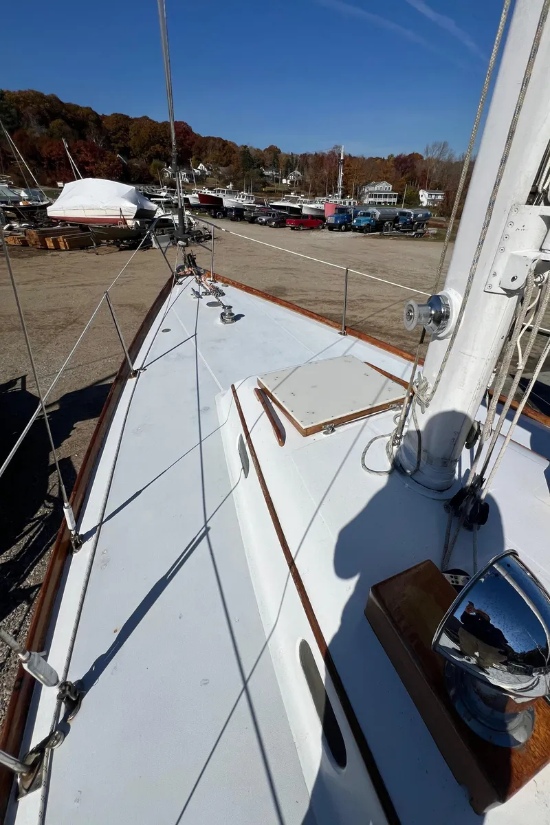 Slide: The Image of 1967 Hinckley Bermuda sailboat deck with marina background. - 8