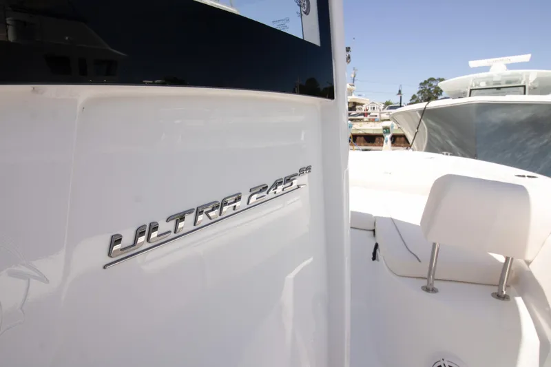 Slide: The Image of 2025 Sea Hunt Ultra 245 SE boat, sleek design, white exterior, close-up view. - 3