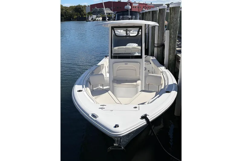 Slide: The Image of 2025 Sea Hunt Ultra 245 SE boat docked in a marina, showcasing sleek design. - 6