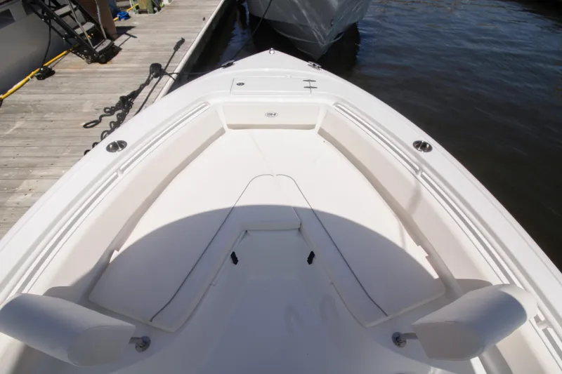 Slide: The Image of 2025 Sea Hunt Ultra 245 SE boat interior with spacious seating at dock. - 7