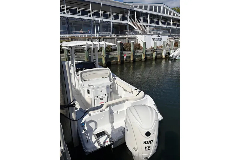 Slide: The Image of 2025 Sea Hunt Ultra 245 SE boat docked at marina with Yamaha 300 engine. - 9