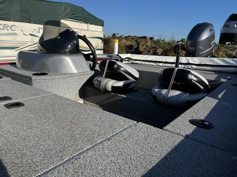 Slide: The Image of 2015 G3 Eagle 176 boat interior with seats and motor, docked outdoors. - 4