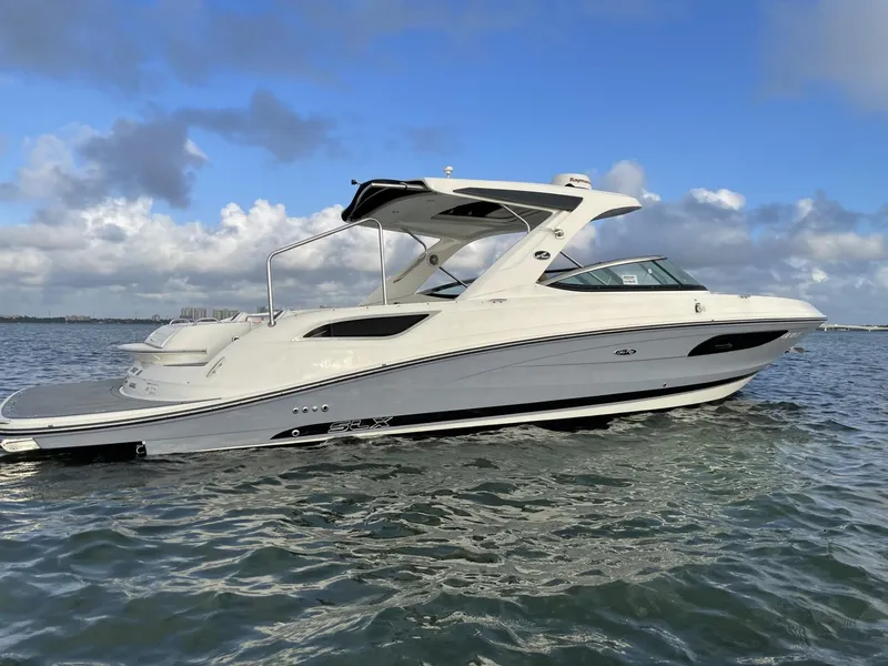 The Image of 2016 Sea Ray 350 SLX boat cruising on open water under a blue sky. - 0