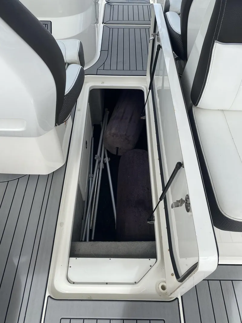 Slide: The Image of 2016 Sea Ray 350 SLX boat storage compartment with open hatch. - 10