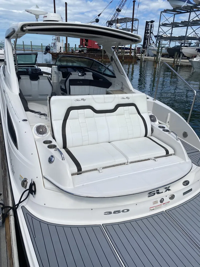 Slide: The Image of 2016 Sea Ray 350 SLX luxury boat docked, featuring sleek design and spacious seating. - 2