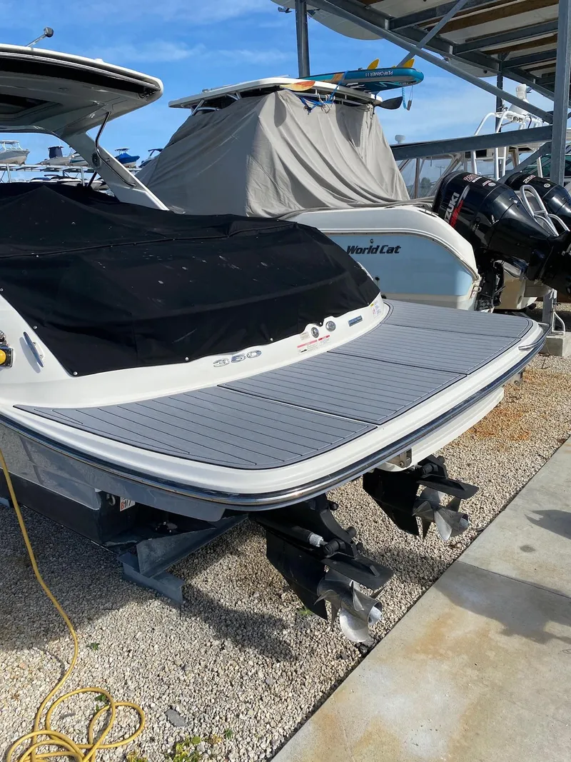Slide: The Image of 2016 Sea Ray 350 SLX boat with covered deck and dual outboard motors. - 22