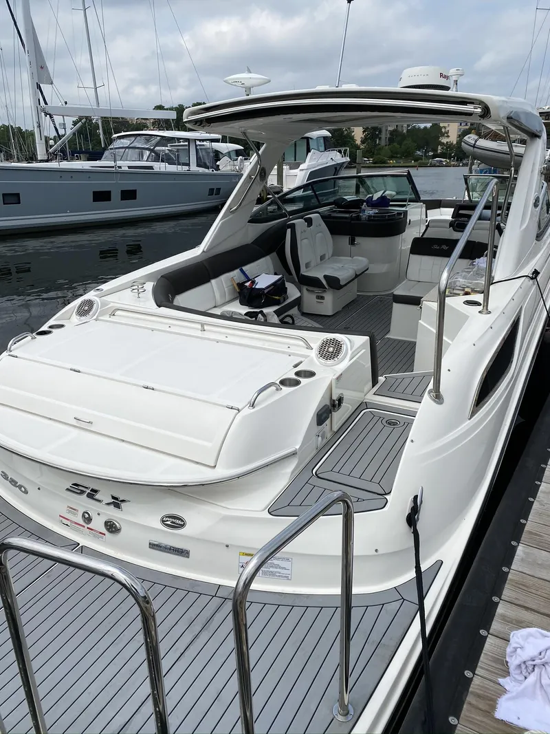 Slide: The Image of 2016 Sea Ray 350 SLX luxury boat docked at marina. - 23