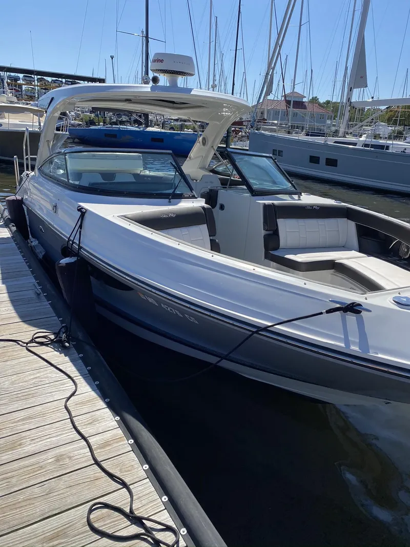 Slide: The Image of 2016 Sea Ray 350 SLX boat docked at marina, sleek design, sunny day. - 25
