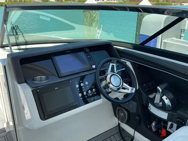 Slide: The Image of Cockpit of 2016 Sea Ray 350 SLX boat with steering wheel and control panel. - 36