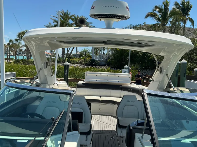 Slide: The Image of 2016 Sea Ray 350 SLX boat with spacious seating and modern design, docked near palm trees. - 38
