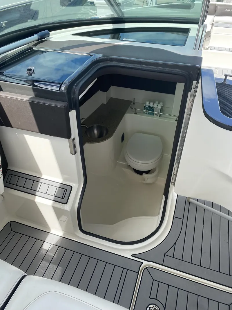 Slide: The Image of 2016 Sea Ray 350 SLX boat interior with compact bathroom and modern design. - 7