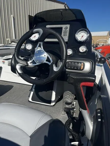 Slide: The Image of 2011 Nitro Z9 boat dashboard with steering wheel and gauges. - 7