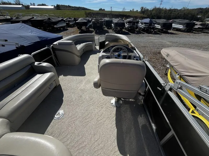 Slide: The Image of 2011 South Bay 522CR pontoon boat interior with seating and steering wheel. - 6