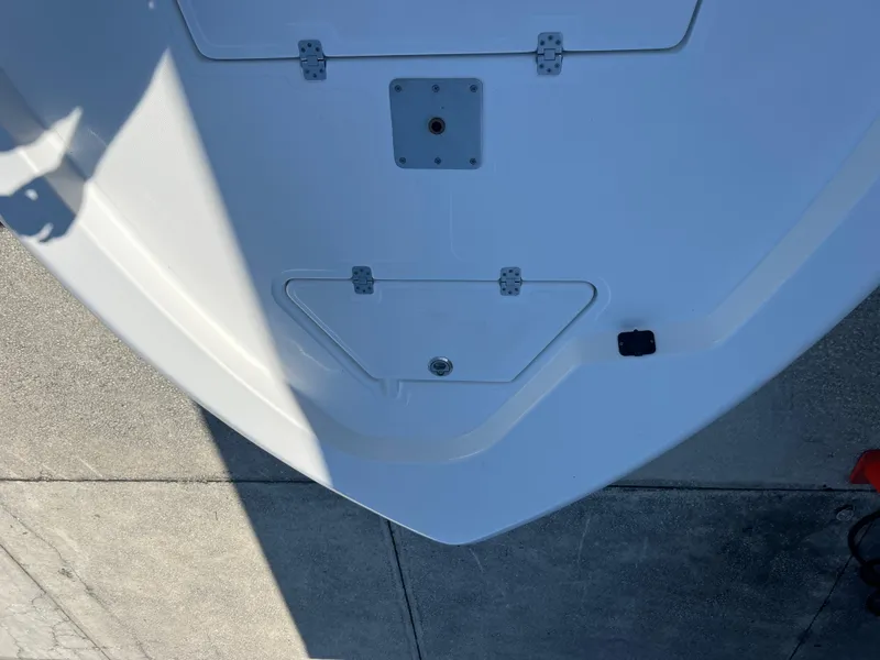 Slide: The Image of 2025 NauticStar 224 Bay boat deck, top view, showing storage compartments. - 12