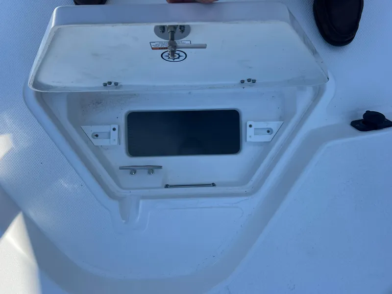 Slide: The Image of Open storage compartment on 2025 NauticStar 224 Bay boat deck. - 13