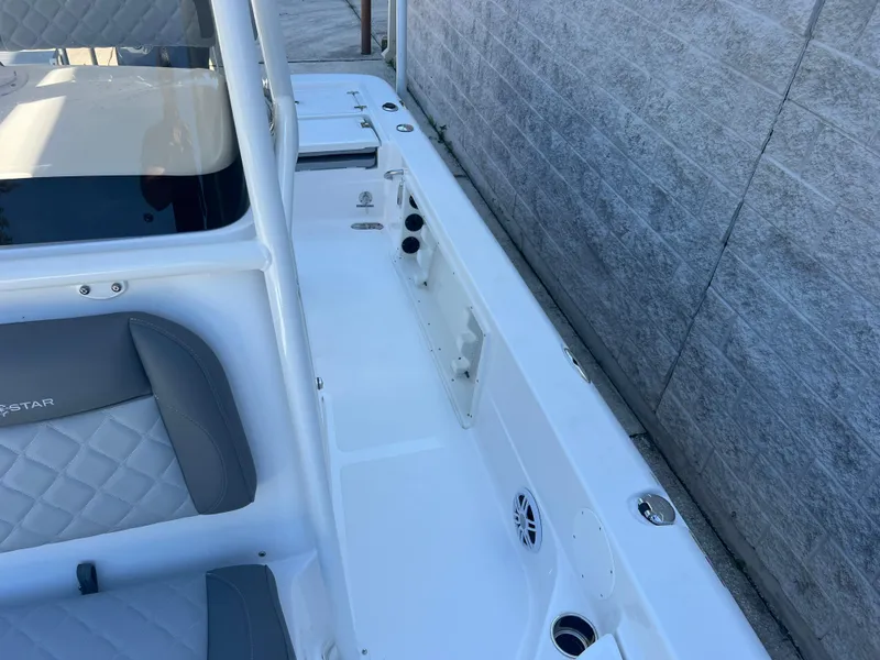 Slide: The Image of 2025 NauticStar 224 Bay boat interior with gray seating and white deck. - 14