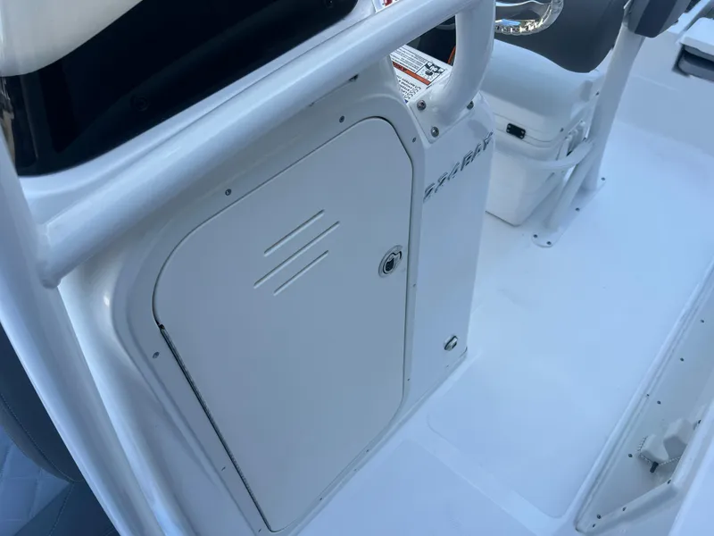 Slide: The Image of 2025 NauticStar 224 Bay boat interior, featuring a sleek white storage compartment. - 15