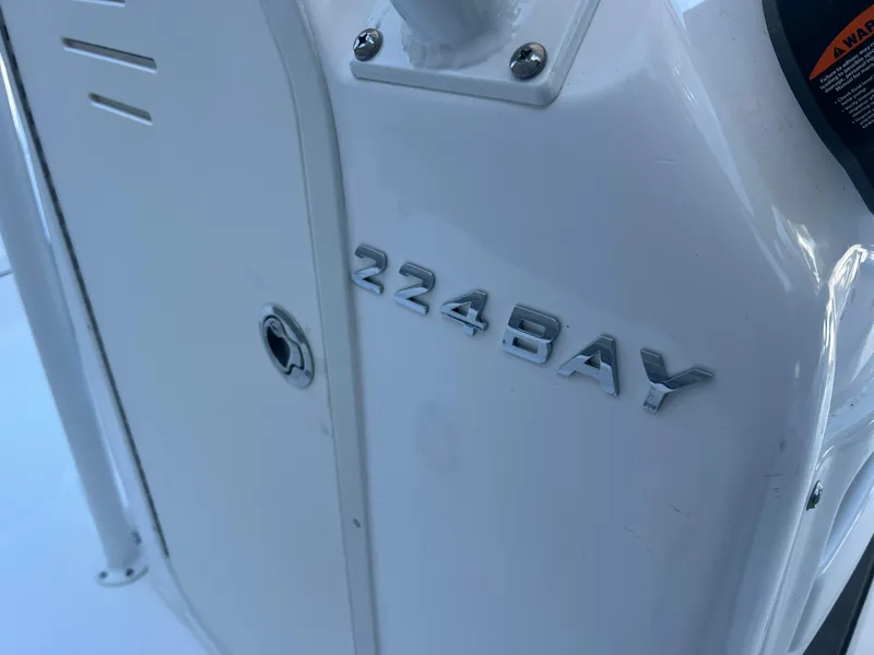 Slide: The Image of 2025 NauticStar 224 Bay boat detail with model name on white surface. - 17