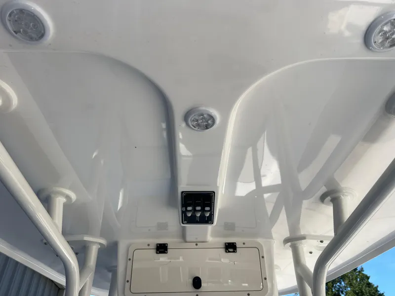 Slide: The Image of 2025 NauticStar 224 Bay boat interior ceiling with lights and control panel. - 2