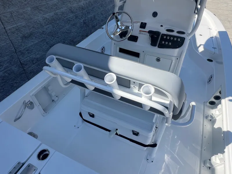 Slide: The Image of 2025 NauticStar 224 Bay boat interior with steering console and rod holders. - 20