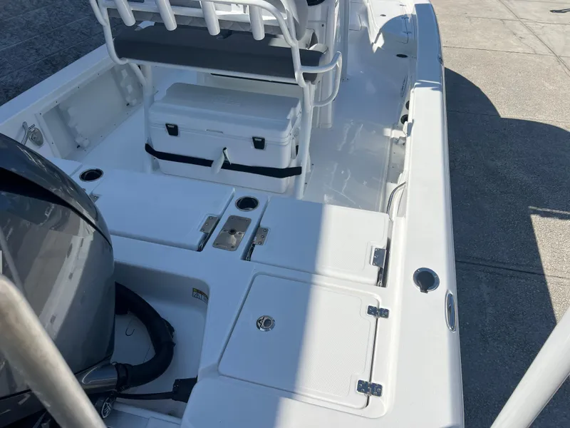 Slide: The Image of 2025 NauticStar 224 Bay boat interior with seating and storage compartments. - 27