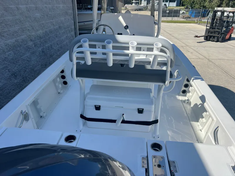 Slide: The Image of 2025 NauticStar 224 Bay boat interior with seating and rod holders. - 29