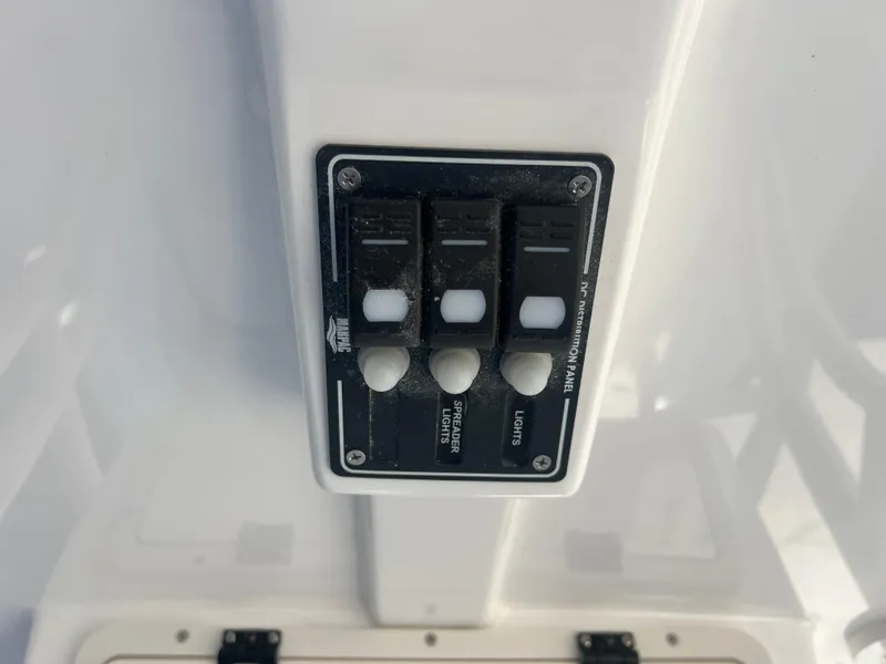 Slide: The Image of Control panel on 2025 NauticStar 224 Bay boat with labeled switches. - 3