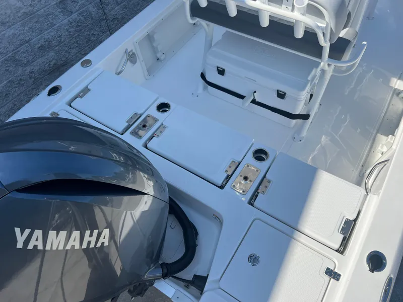 Slide: The Image of 2025 NauticStar 224 Bay boat interior with Yamaha engine, featuring storage compartments and seating. - 30