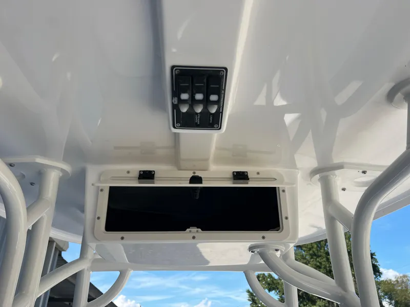 Slide: The Image of 2025 NauticStar 224 Bay boat console with storage compartment and control panel. - 4