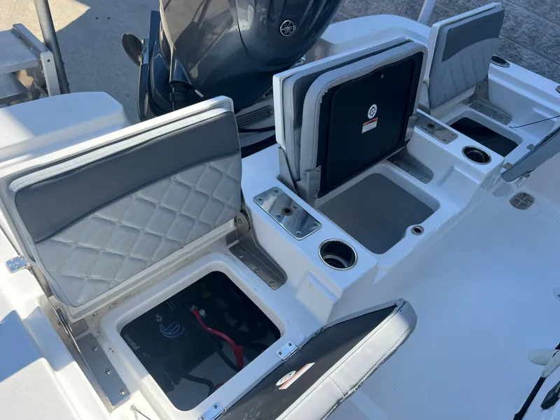 Slide: The Image of 2025 NauticStar 224 Bay boat interior with open storage compartments and seating. - 41