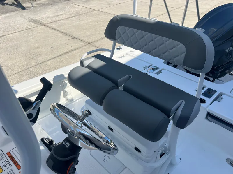 Slide: The Image of 2025 NauticStar 224 Bay boat interior with steering wheel and cushioned seating. - 42
