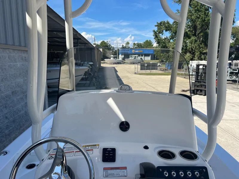 Slide: The Image of 2025 NauticStar 224 Bay boat dashboard with steering wheel and controls. - 44