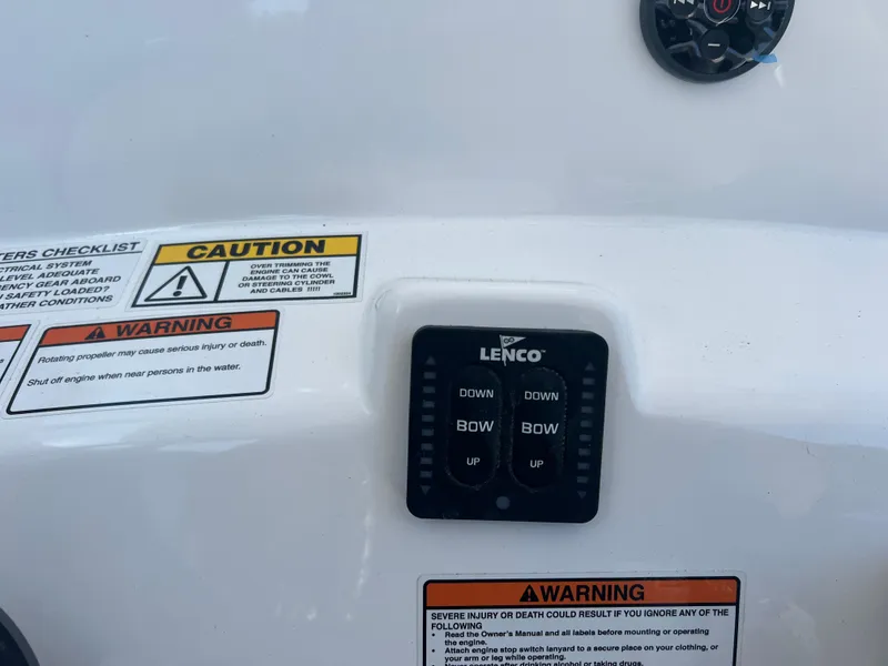 Slide: The Image of Control panel on 2025 NauticStar 224 Bay boat with caution and warning labels. - 45