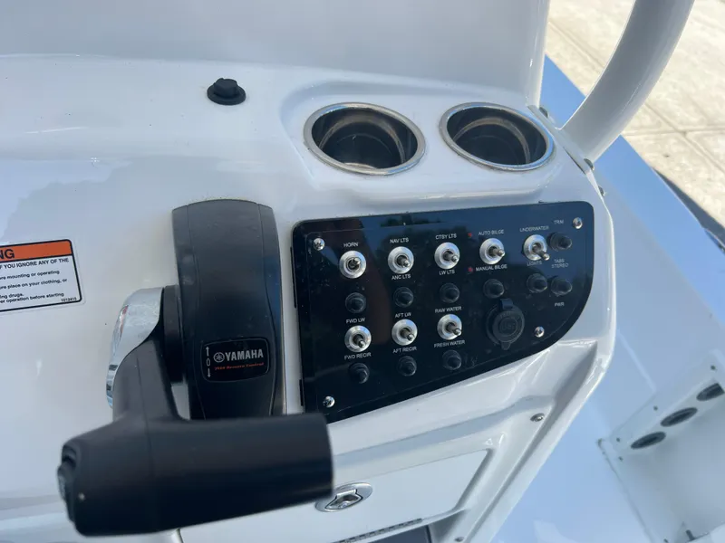 Slide: The Image of Control panel of 2025 NauticStar 224 Bay boat with Yamaha throttle and switches. - 47
