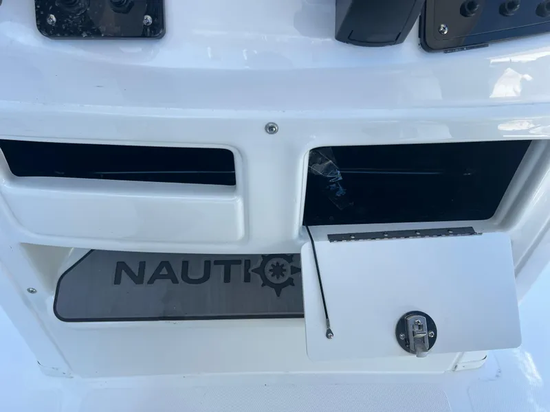 Slide: The Image of 2025 NauticStar 224 Bay boat storage compartment with open hatch. - 49