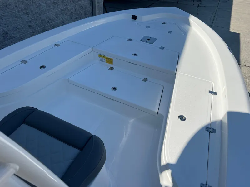 Slide: The Image of 2025 NauticStar 224 Bay boat interior with seating and storage compartments. - 6