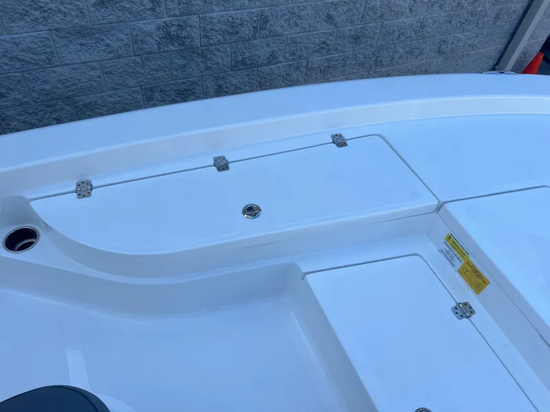 Slide: The Image of 2025 NauticStar 224 Bay boat deck with storage compartments. - 9