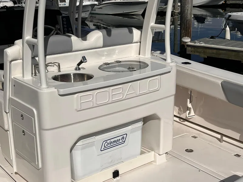 Slide: The Image of 2023 Robalo R302 Center Console boat with sink and Coleman cooler. - 10