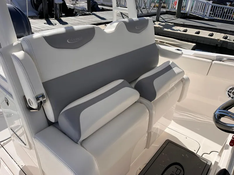 Slide: The Image of 2023 Robalo R302 Center Console boat seating with gray and white cushioned design. - 11