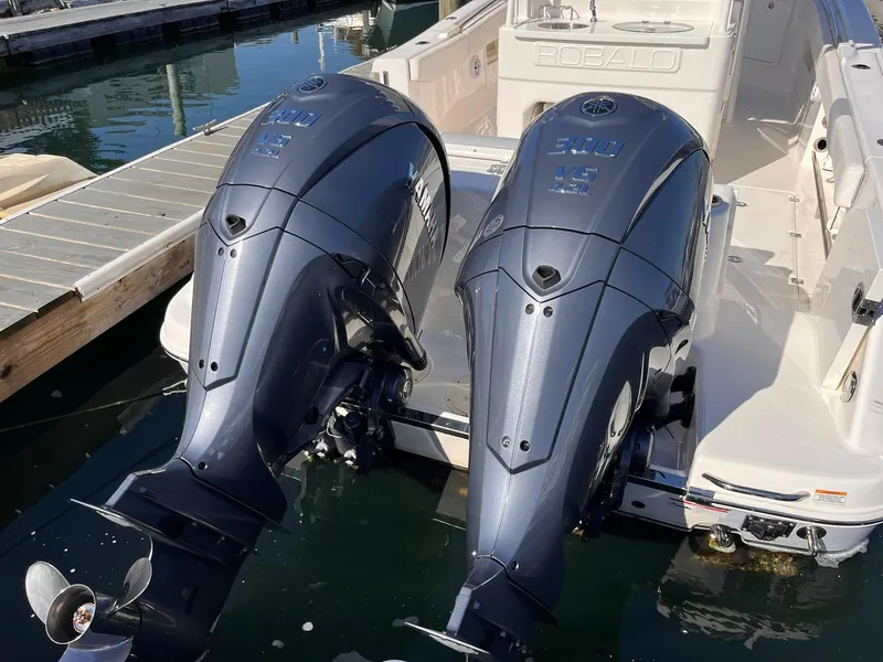 Slide: The Image of 2023 Robalo R302 Center Console with dual outboard engines docked at marina. - 3